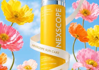 Yellow Nexscope sun care bottle surrounded by colorful flowers