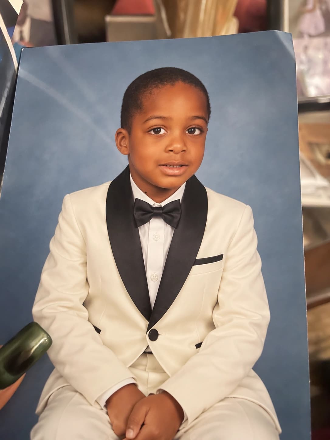 OpenAI Images 2.5 edited portrait showing the child in an ivory tuxedo against a blue background