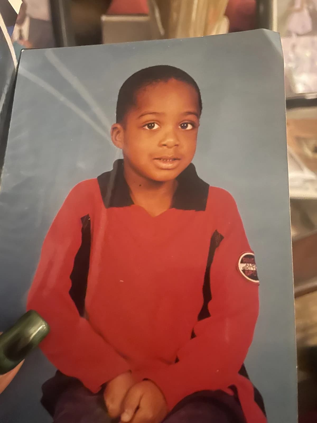 OpenAI reference portrait showing a child in a red shirt against a blue studio background