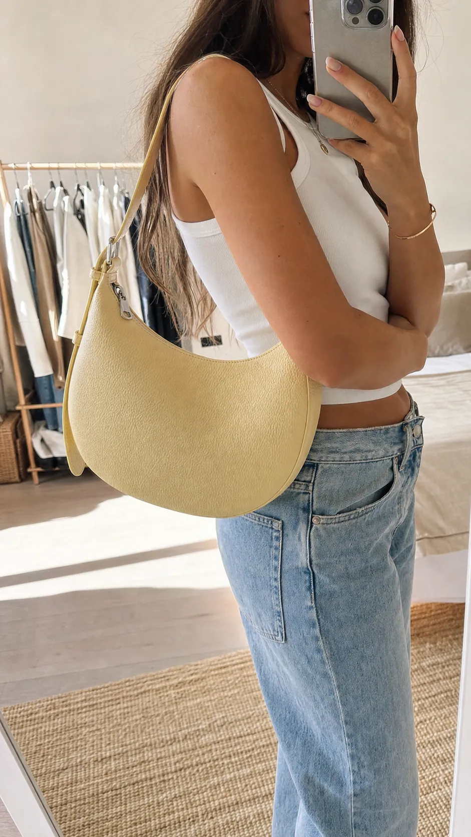 Fashion creator filming a yellow handbag mirror selfie