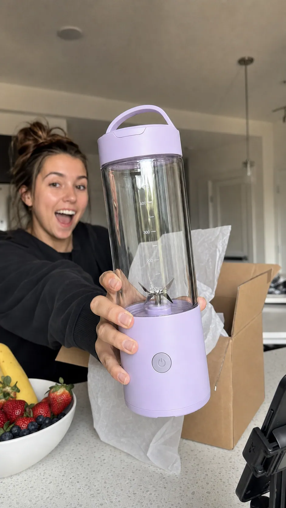 Creator unboxing and demonstrating a portable blender